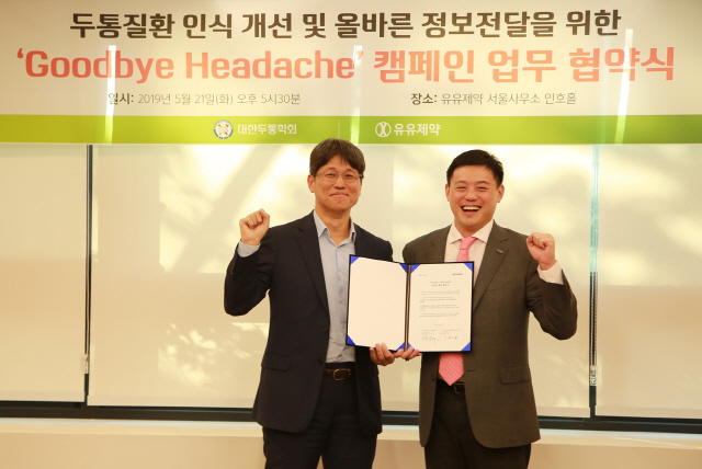유원상(오른쪽) 유유제약 대표가 김병건 대한두통학회 회장과 전략적 제휴협약(MOU)을 체결 후 기념촬영을 하고 있다.